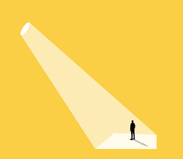 Three-color flat illustration of a person standing in a spotlight. The background is yellow, the spotlight is white, the figure is black